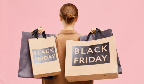 Carrying black Friday paperbags